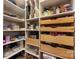 Well-organized pantry with shelves and wooden drawers, providing ample storage for food and kitchen essentials at 13107 Heath Grove Dr, Huntersville, NC 28078