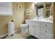 Bright bathroom with white vanity, toilet, and stacked washer/dryer at 1609 Troy Rd, Shelby, NC 28150