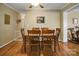 Bright dining room featuring hardwood floors, a ceiling fan, and a classic wooden dining set at 1609 Troy Rd, Shelby, NC 28150