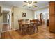 Bright dining room featuring hardwood floors, a ceiling fan, and a classic wooden dining set at 1609 Troy Rd, Shelby, NC 28150
