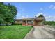 Single-story brick home with an attached carport and a long driveway on a sunny day at 1609 Troy Rd, Shelby, NC 28150
