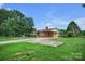 Sprawling front yard with a brick home featuring an attached carport and ample parking space at 1609 Troy Rd, Shelby, NC 28150