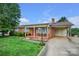 Charming brick home featuring a cozy front porch and a well-manicured lawn with mature landscaping at 1609 Troy Rd, Shelby, NC 28150