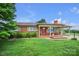 Quaint brick home featuring a covered porch, tidy landscaping, and a well-manicured front lawn at 1609 Troy Rd, Shelby, NC 28150