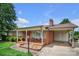 Charming brick home featuring a covered front porch and well-manicured landscaping at 1609 Troy Rd, Shelby, NC 28150