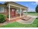 Charming brick home with a covered front porch, red door, and beautiful landscaping at 1609 Troy Rd, Shelby, NC 28150