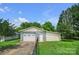 Detached garage with ample space for parking and storage, complemented by a neatly kept lawn at 1609 Troy Rd, Shelby, NC 28150