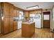 Traditional kitchen featuring oak cabinets, white appliances, an island, and hardwood flooring at 1609 Troy Rd, Shelby, NC 28150