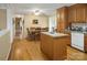 Cozy kitchen featuring an island, wooden cabinetry, and an adjacent dining area at 1609 Troy Rd, Shelby, NC 28150