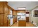 Traditional kitchen featuring oak cabinets, white appliances, an island, and hardwood flooring at 1609 Troy Rd, Shelby, NC 28150