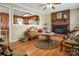 Inviting living room with hardwood floors, brick fireplace, and a clear view into the adjacent kitchen at 1609 Troy Rd, Shelby, NC 28150