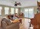 Bright living room with hardwood floors, a ceiling fan, and access to an outdoor deck at 1609 Troy Rd, Shelby, NC 28150