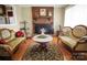 Cozy living room with a brick fireplace, hardwood floors, and elegant furnishings at 1609 Troy Rd, Shelby, NC 28150
