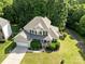 Stunning aerial view of a two-story home with lush landscaping and a private backyard at 161 Dairy Farm Rd, Mooresville, NC 28115