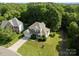 Expansive aerial shot of a two-story home with a lush green lawn and mature trees at 161 Dairy Farm Rd, Mooresville, NC 28115