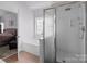 Bright bathroom featuring a shower, tub, and a view of the bedroom at 161 Dairy Farm Rd, Mooresville, NC 28115