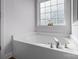 A bright white bathtub is featured under a window in this bathroom at 161 Dairy Farm Rd, Mooresville, NC 28115