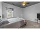 Comfortable bedroom featuring neutral tones, a ceiling fan, and a bright window view at 161 Dairy Farm Rd, Mooresville, NC 28115