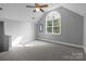 Bright bonus room featuring a neutral carpet and a large arched window at 161 Dairy Farm Rd, Mooresville, NC 28115