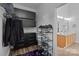Functional closet with storage shelves, drawers, and a view of the bright, tiled bathroom at 161 Dairy Farm Rd, Mooresville, NC 28115