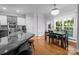 Dining area open to kitchen with hardwood floors and views of the backyard at 161 Dairy Farm Rd, Mooresville, NC 28115