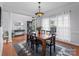Formal dining room with a wooden table, seating for six, and decorative chandelier at 161 Dairy Farm Rd, Mooresville, NC 28115