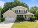 Charming two-story brick home with a well-manicured lawn and a welcoming front porch at 161 Dairy Farm Rd, Mooresville, NC 28115