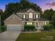 Inviting two-story brick home with a well-kept lawn and an attached two-car garage at 161 Dairy Farm Rd, Mooresville, NC 28115