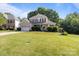 Charming two-story brick home featuring a well-manicured lawn and welcoming front porch at 161 Dairy Farm Rd, Mooresville, NC 28115