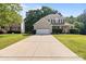Stately two-story home featuring a wide driveway and beautifully landscaped front yard at 161 Dairy Farm Rd, Mooresville, NC 28115