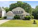 Beautiful two-story home with lush front lawn, manicured shrubs, and a two-car garage at 161 Dairy Farm Rd, Mooresville, NC 28115