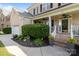 Charming front porch with brick steps, decorative planters, and manicured bushes at 161 Dairy Farm Rd, Mooresville, NC 28115