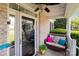 Inviting front porch with a wicker couch, colorful pillows, and a view of the entryway at 161 Dairy Farm Rd, Mooresville, NC 28115