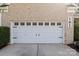 Spacious two-car garage with classic paneled doors and clean concrete driveway at 161 Dairy Farm Rd, Mooresville, NC 28115