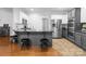 Kitchen island with seating for three and stainless steel appliances at 161 Dairy Farm Rd, Mooresville, NC 28115