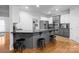 Kitchen island with seating, stainless appliances, and hardwood floors at 161 Dairy Farm Rd, Mooresville, NC 28115