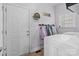 Functional laundry room featuring a washer, dryer, storage, and door to the outside at 161 Dairy Farm Rd, Mooresville, NC 28115