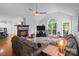 Cozy living room with a stone fireplace, hardwood floors, and vaulted ceiling at 161 Dairy Farm Rd, Mooresville, NC 28115