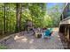 Relax on the outdoor patio with a stone fireplace and outdoor seating at 161 Dairy Farm Rd, Mooresville, NC 28115