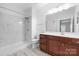 Bathroom with walk-in shower with marble tile and dark wood vanity at 17111 Doe Valley Ct, Cornelius, NC 28031