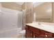Bathroom with shower-tub, white tiled walls, and single sink vanity at 17111 Doe Valley Ct, Cornelius, NC 28031