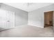 This carpeted bedroom includes a ceiling fan and a closet at 17111 Doe Valley Ct, Cornelius, NC 28031