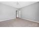 Bedroom featuring neutral carpet and light gray walls with a closet at 17111 Doe Valley Ct, Cornelius, NC 28031