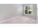 Bedroom featuring a window with blinds and light-colored carpet at 17111 Doe Valley Ct, Cornelius, NC 28031
