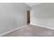 Bedroom featuring neutral carpet and light gray walls with a window at 17111 Doe Valley Ct, Cornelius, NC 28031