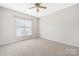 Bedroom features neutral carpet and a window at 17111 Doe Valley Ct, Cornelius, NC 28031