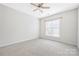 Bedroom features neutral carpet and large window at 17111 Doe Valley Ct, Cornelius, NC 28031