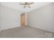 Bedroom with neutral carpet, ceiling fan, and open doorway at 17111 Doe Valley Ct, Cornelius, NC 28031