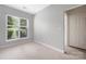 Bedroom featuring a window with blinds and light-colored carpet at 17111 Doe Valley Ct, Cornelius, NC 28031