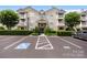 Inviting condo building with well-maintained landscaping, parking, and balconies on a sunny day at 17111 Doe Valley Ct, Cornelius, NC 28031